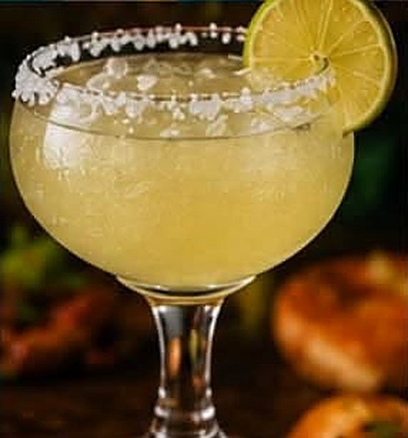 Margarita with a salted rim and a lime wheel